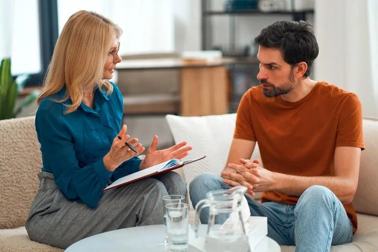 An adult discussing support with a professional