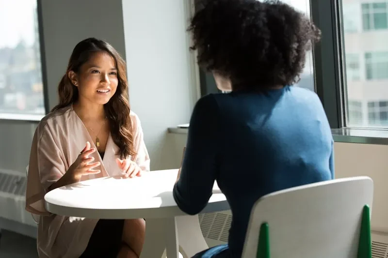 Two adults discussing support options