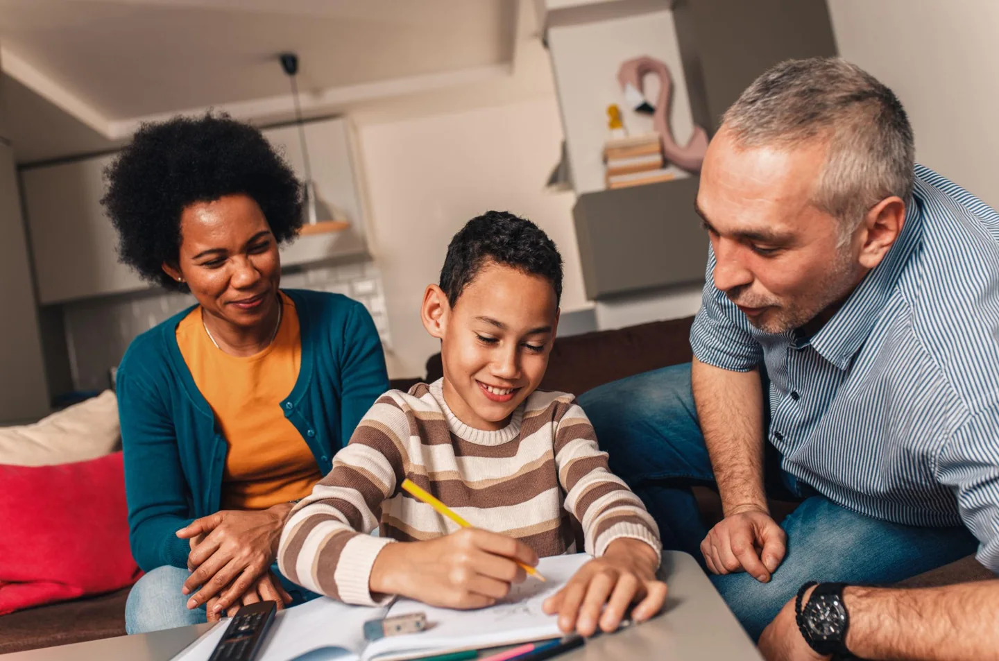 A child and two adults working on an activity together